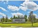 Community sign with the 'Waterleaf' logo set against a blue sky at 13113 Green Violet Dr, Riverview, FL 33579