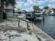 A waterfront property featuring a private dock and boat lift on a canal, perfect for boating enthusiasts at 13605 Stacey Dr, Hudson, FL 34667