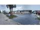 Charming single Gathering home featuring a spacious driveway and lush palm trees in a waterfront community at 13605 Stacey Dr, Hudson, FL 34667
