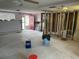 A fixer-upper living area shows renovation potential with exposed framing, ready for transformation into a cozy home at 13605 Stacey Dr, Hudson, FL 34667