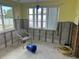 An unfinished living area offers a blank canvas, awaiting renovation with new windows and ample natural light at 13605 Stacey Dr, Hudson, FL 34667