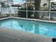 Backyard featuring a refreshing screened-in pool with clean, clear water, perfect for outdoor relaxation at 13605 Stacey Dr, Hudson, FL 34667