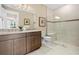 This bathroom features a granite countertop vanity and glass-enclosed shower at 14317 Eagle Branch Dr, Nokomis, FL 34275