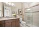This bathroom features a granite countertop vanity and glass-enclosed shower at 14317 Eagle Branch Dr, Nokomis, FL 34275