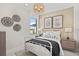 This cozy bedroom features stylish decor and a sunlit window view at 14317 Eagle Branch Dr, Nokomis, FL 34275