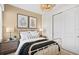 This comfortable bedroom has a decorative light and a sunlit window view at 14317 Eagle Branch Dr, Nokomis, FL 34275