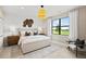 Bedroom with a large window with a view, big bed, modern lighting and side tables, and decorative wall art at 14317 Eagle Branch Dr, Nokomis, FL 34275