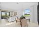 Bright dining area and living room area with tile floors, big windows, modern lighting, and comfortable decor at 14317 Eagle Branch Dr, Nokomis, FL 34275