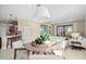 Bright dining area with a round table, wooden chairs, modern pendant lighting and view to the living area at 14317 Eagle Branch Dr, Nokomis, FL 34275
