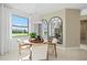 Dining area featuring a round wooden table, chairs, modern lighting, large window with a yard view, and decorative mirrors at 14317 Eagle Branch Dr, Nokomis, FL 34275