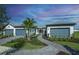 Beautiful single-story home with a three-car garage, a stone walkway, and lush landscaping at 14317 Eagle Branch Dr, Nokomis, FL 34275