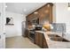 Modern kitchen with stainless steel appliances, white countertops and dark cabinets with a breakfast nook at 14317 Eagle Branch Dr, Nokomis, FL 34275