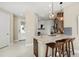 Open-concept kitchen with granite countertops, stainless steel appliances, and a breakfast bar at 14317 Eagle Branch Dr, Nokomis, FL 34275