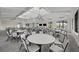 Spacious meeting room with abundant seating, a vaulted ceiling, large windows, and modern chandeliers at 14317 Eagle Branch Dr, Nokomis, FL 34275