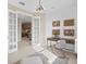 This home office features french doors, paneled walls and modern light fixture at 14317 Eagle Branch Dr, Nokomis, FL 34275