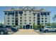 Exterior of multi-story condo building with a well-kept parking area out front at 14820 Rue De Bayonne # 301, Clearwater, FL 33762