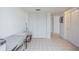 Hallway featuring tile floors, utility access, and two storage closets at 14820 Rue De Bayonne # 301, Clearwater, FL 33762