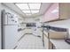 A compact kitchen features neutral colors, ample storage, and a skylight overhead at 14820 Rue De Bayonne # 301, Clearwater, FL 33762