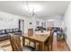 Open concept living room with dining room has hardwood floors and neutral paint tones at 14820 Rue De Bayonne # 301, Clearwater, FL 33762