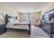 Comfortable main bedroom featuring a large bed, side tables, and a dresser with a television at 14820 Rue De Bayonne # 301, Clearwater, FL 33762