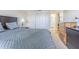 Main bedroom featuring a large bed, neutral walls and carpet, and private bathroom access at 14820 Rue De Bayonne # 301, Clearwater, FL 33762