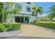 Street level garage entrance to underground parking with ample green space surrounding the driveway at 14820 Rue De Bayonne # 301, Clearwater, FL 33762
