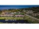 Aerial view of the community with a canal, pool, and building exteriors showcasing landscaping and coastal setting at 1729 Seascape Cir # 102, Tarpon Springs, FL 34689