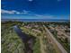 An aerial view of a waterfront community with a bay view, lush landscaping, and a swimming pool at 1729 Seascape Cir # 102, Tarpon Springs, FL 34689