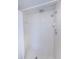 Bathroom features a shower with white tile, tiled floors and a shower seat at 1729 Seascape Cir # 102, Tarpon Springs, FL 34689
