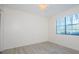 Bedroom with a window and neutral walls, and wood-look floors at 1729 Seascape Cir # 102, Tarpon Springs, FL 34689
