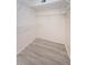 Walk-in closet with built-in wire shelving and wood-look floors at 1729 Seascape Cir # 102, Tarpon Springs, FL 34689