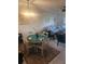 Dining area with a round table, seating for four, and a view into the living room at 1729 Seascape Cir # 102, Tarpon Springs, FL 34689