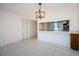 Bright dining room features tile floors, modern light fixture and a pass-through to the kitchen at 1729 Seascape Cir # 102, Tarpon Springs, FL 34689