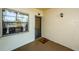 Condo entrance with a storm door, window with curtains, a doormat, and beige exterior walls at 1729 Seascape Cir # 102, Tarpon Springs, FL 34689