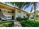 Condo exterior with lush landscaping, walkway and a view of the two-story building at 1729 Seascape Cir # 102, Tarpon Springs, FL 34689