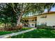 Inviting condo exterior with lush landscaping, walkway and a view of the two-story building at 1729 Seascape Cir # 102, Tarpon Springs, FL 34689