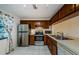 Functional kitchen with stainless steel appliances, wood cabinets, and tiled flooring at 1729 Seascape Cir # 102, Tarpon Springs, FL 34689