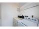 Laundry room with washer, dryer, and wire shelving for storage at 1729 Seascape Cir # 102, Tarpon Springs, FL 34689