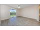 Bright living room features wood-look floors and sliding glass doors opening to the backyard at 1729 Seascape Cir # 102, Tarpon Springs, FL 34689