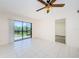 Bright living room with tiled floor and sliding glass doors opening to the backyard at 1729 Seascape Cir # 102, Tarpon Springs, FL 34689