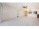 Open-concept living room with tile floors, neutral walls, and a modern ceiling fan at 1729 Seascape Cir # 102, Tarpon Springs, FL 34689