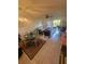 Comfortable living room and dining area with a neutral color palette and sliding glass doors at 1729 Seascape Cir # 102, Tarpon Springs, FL 34689