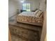 Comfortable main bedroom with soft rug and upholstered headboard overlooking the canal at 1729 Seascape Cir # 102, Tarpon Springs, FL 34689