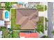 Aerial shot of the house with fenced yard, fire pit, and brown shingle roof at 17838 Morninghigh Dr, Lutz, FL 33549