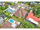 Overhead aerial of property with pool, neighboring houses, and a yard at 17838 Morninghigh Dr, Lutz, FL 33549