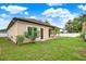 Back of home showcasing back yard, including the patio, and access to the house at 17838 Morninghigh Dr, Lutz, FL 33549