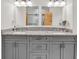 Bathroom featuring a double vanity with granite countertops and a walk-in shower at 17838 Morninghigh Dr, Lutz, FL 33549