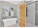Luxury bathroom with a soaking tub and a walk-in shower with a custom wood panel at 17838 Morninghigh Dr, Lutz, FL 33549