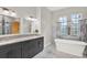 Spacious bathroom with double vanity, granite countertop, soaking tub, and large windows at 17838 Morninghigh Dr, Lutz, FL 33549