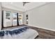 Bright empty bedroom with hardwood floors, bright light, and windows with curtains at 17838 Morninghigh Dr, Lutz, FL 33549
